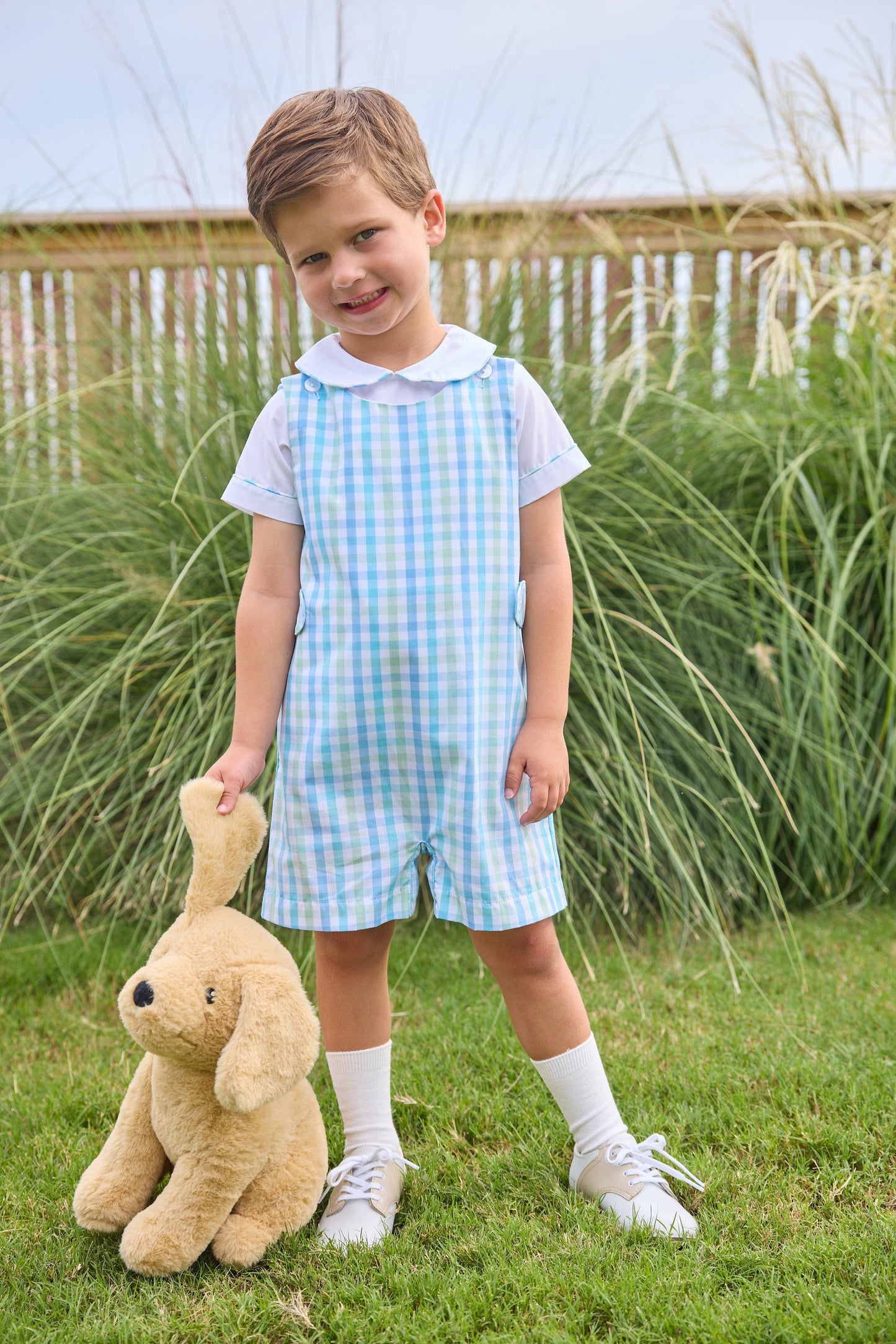 Little English traditional children's clothing. Classic button tab john john set for toddler boys with white peter pan short-sleeve shirt and aqua and green plaid john john