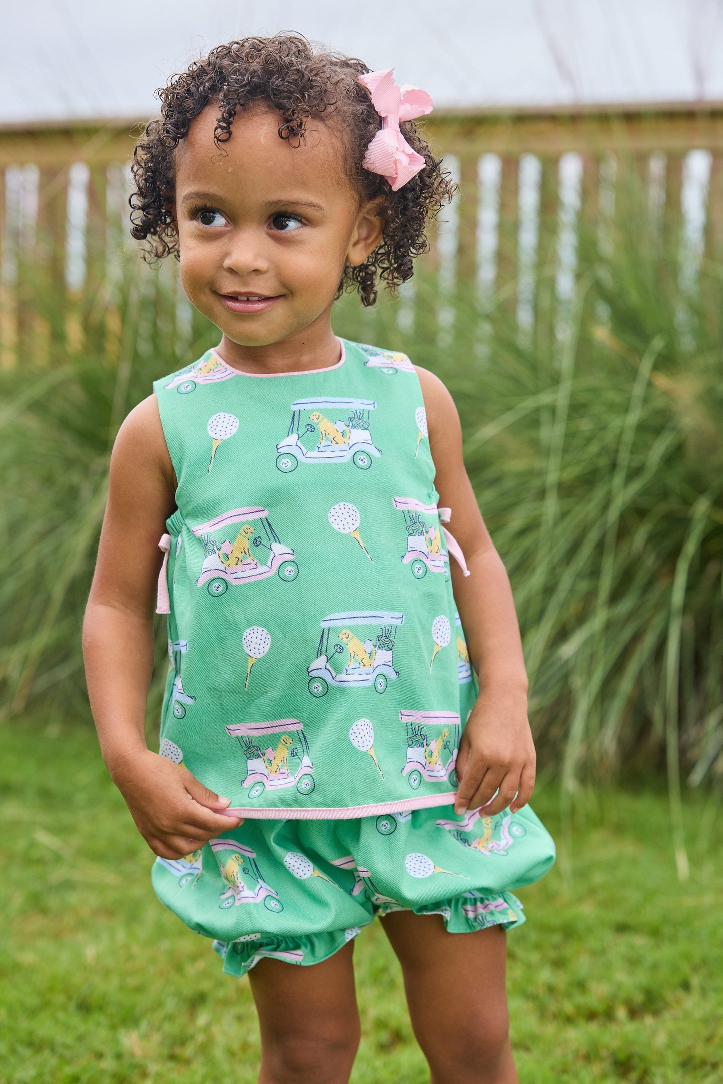 Little English traditional children's clothing. Green and pink two piece set with golf cart print for baby girls.