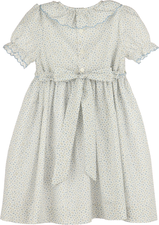 White dress with blue floral pattern on a white background