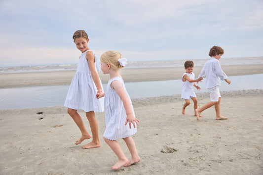 Little English traditional children's clothing. Light blue and white striped sleeveless dress with white ricrac trim for little girls