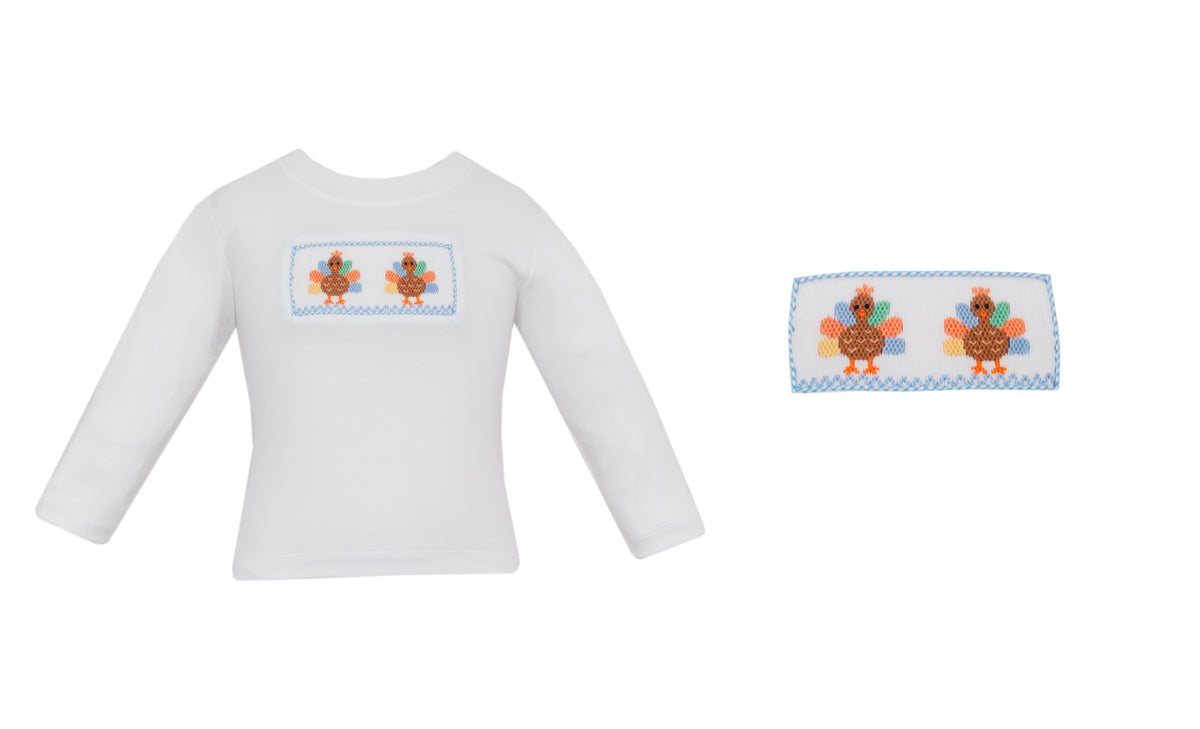 White long-sleeve shirt with embroidered design on a white background