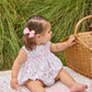Little English traditional children's clothing.  White sleeveless smocked bubble with pink and green florals for baby girls