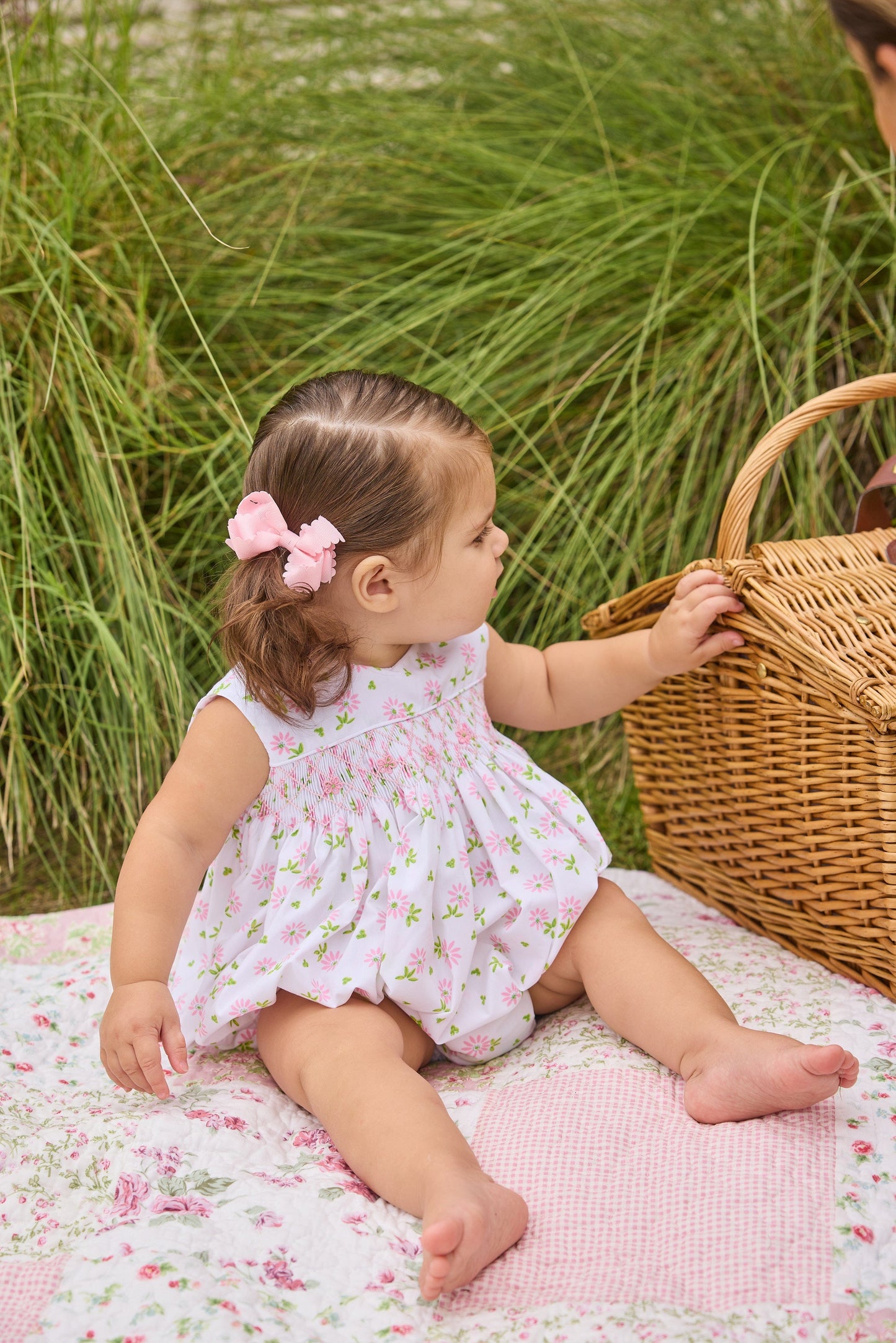 Little English traditional children's clothing.  White sleeveless smocked bubble with pink and green florals for baby girls