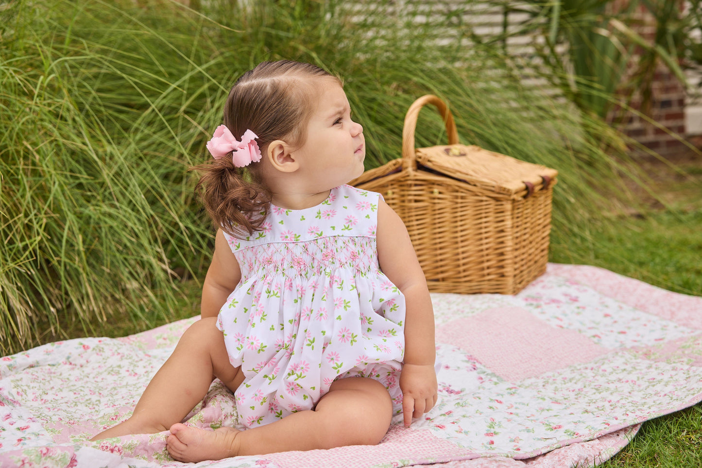 Little English traditional children's clothing.  White sleeveless smocked bubble with pink and green florals for baby girls