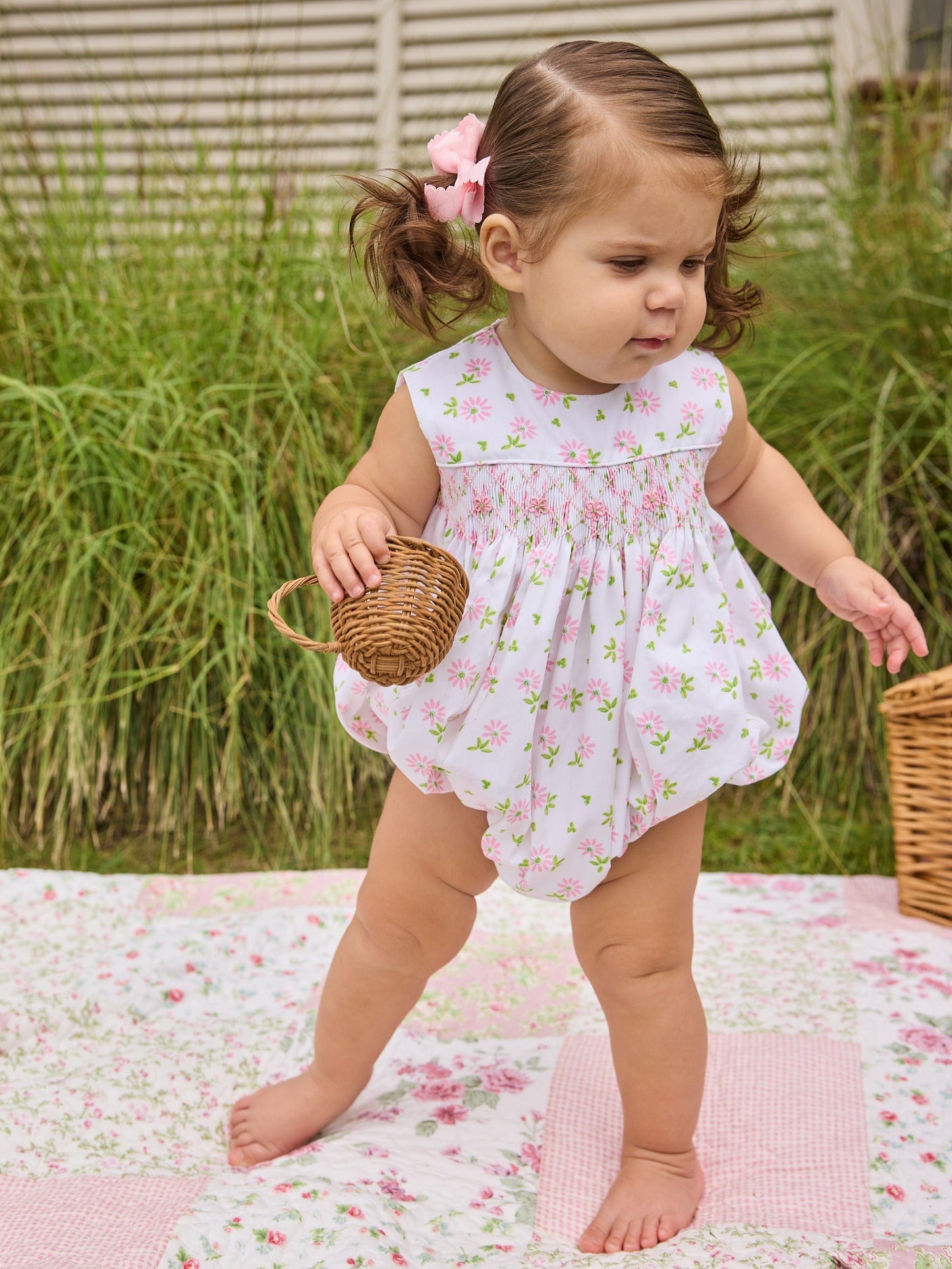 Little English traditional children's clothing.  White sleeveless smocked bubble with pink and green florals for baby girls