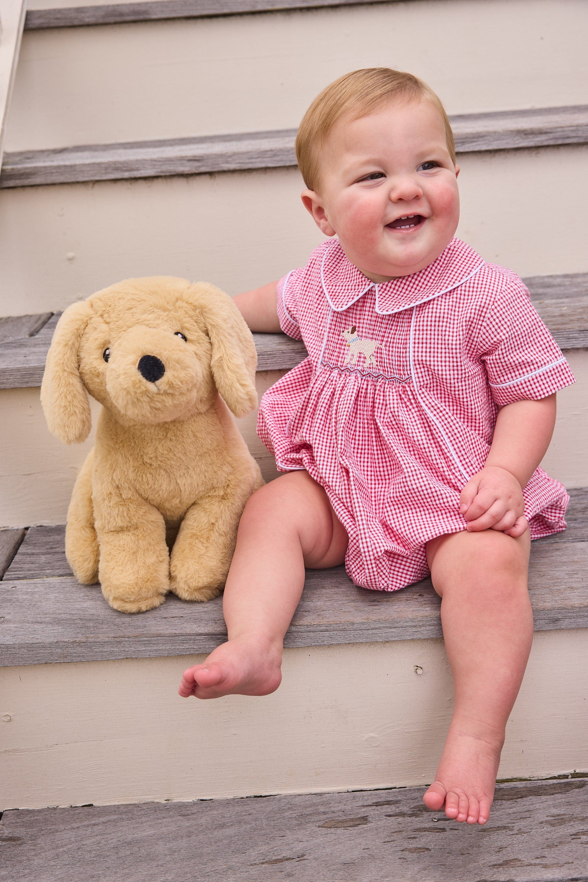 Little English traditional children's clothing.  Classic peter pan bubble for baby boys in red seersucker gingham fabric and lab smocking at the chest
