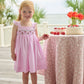 Little English traditional children's clothing.  Light pink seersucker gingham dress for little girls with flutter sleeves and strawberry smocking across the chest