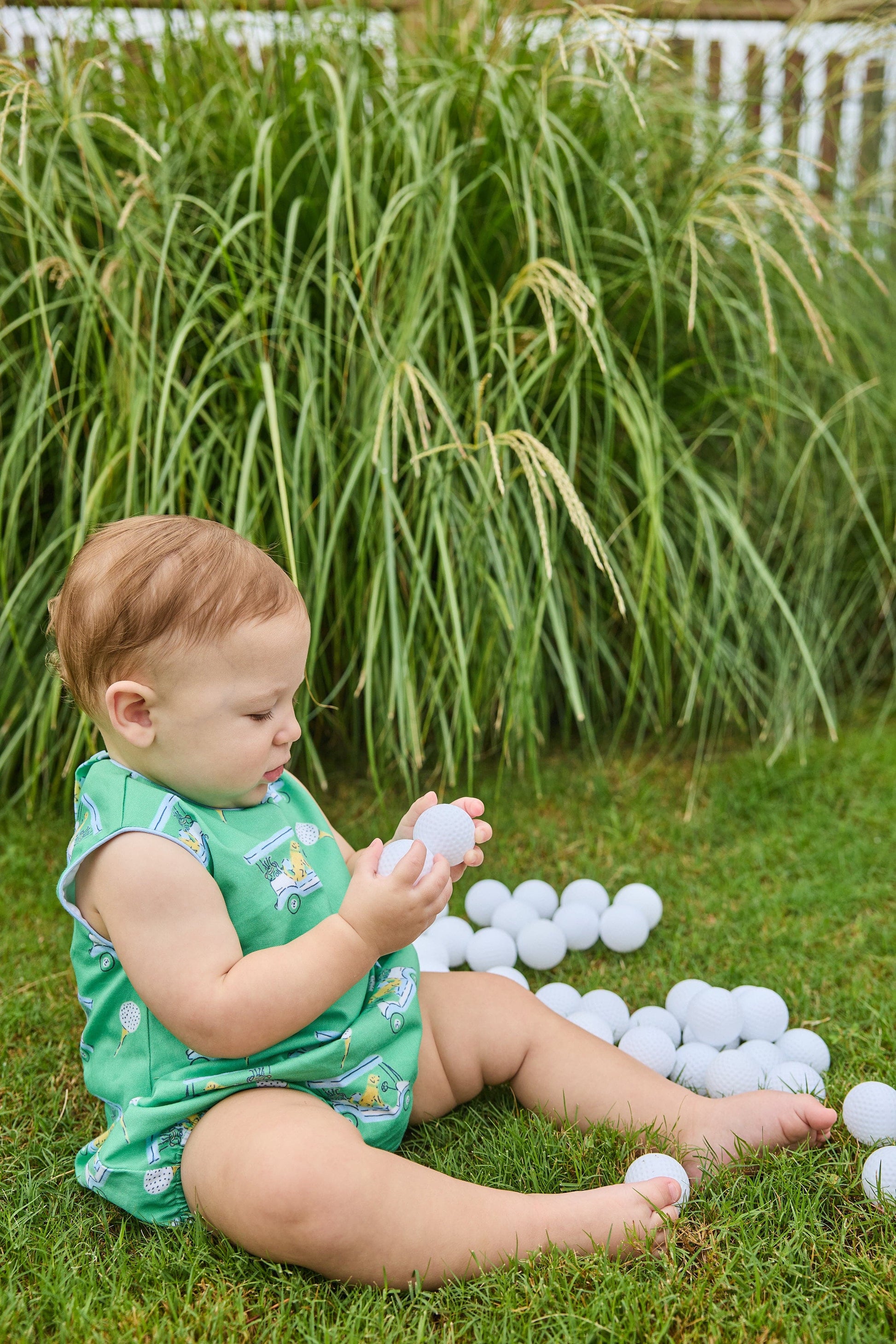 Little English traditional children's clothing.  Green golf cart print bubble for baby boys.