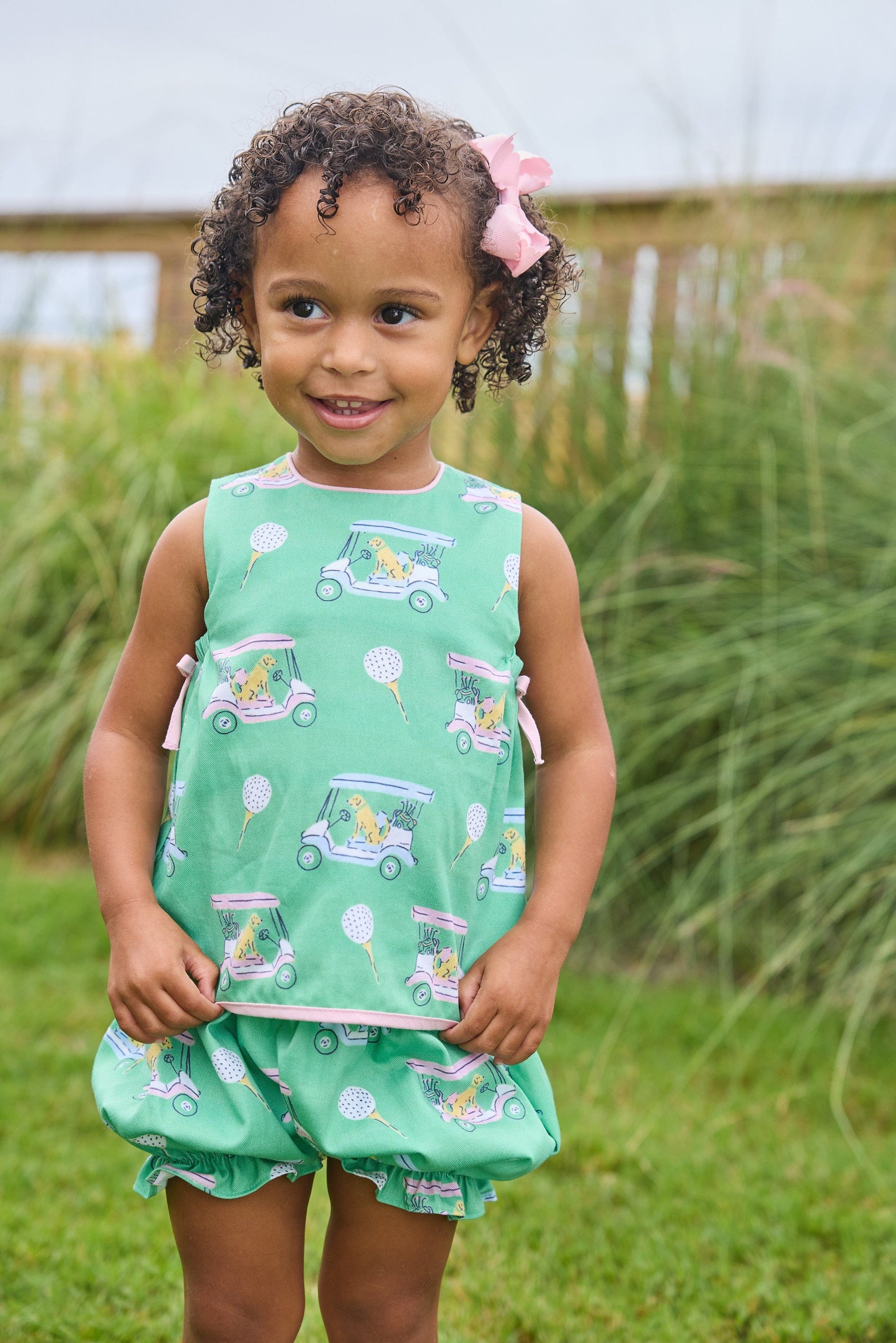 Little English traditional children's clothing.  Green and pink two piece set with golf cart print for baby girls.