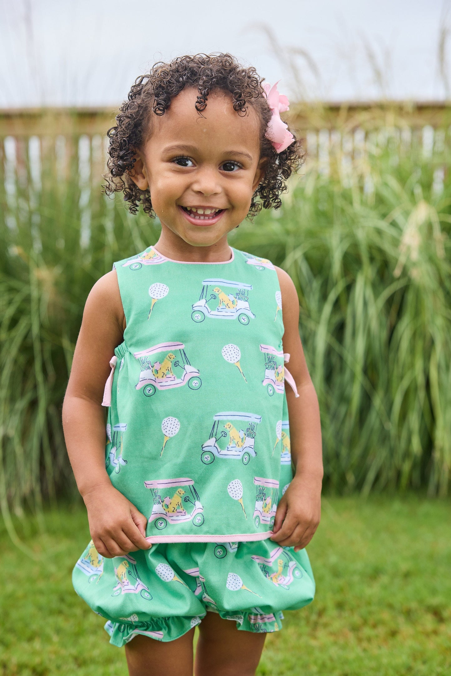Little English traditional children's clothing.  Green and pink two piece set with golf cart print for baby girls.