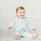 Baby Blue quilted button front hoodie and matching pants.  Worn by a baby boy sitting happily on a wooden floor. 