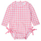 A pink and white gingham one piece rash guard for babies, with bows at the hip and snaps on the bottom.