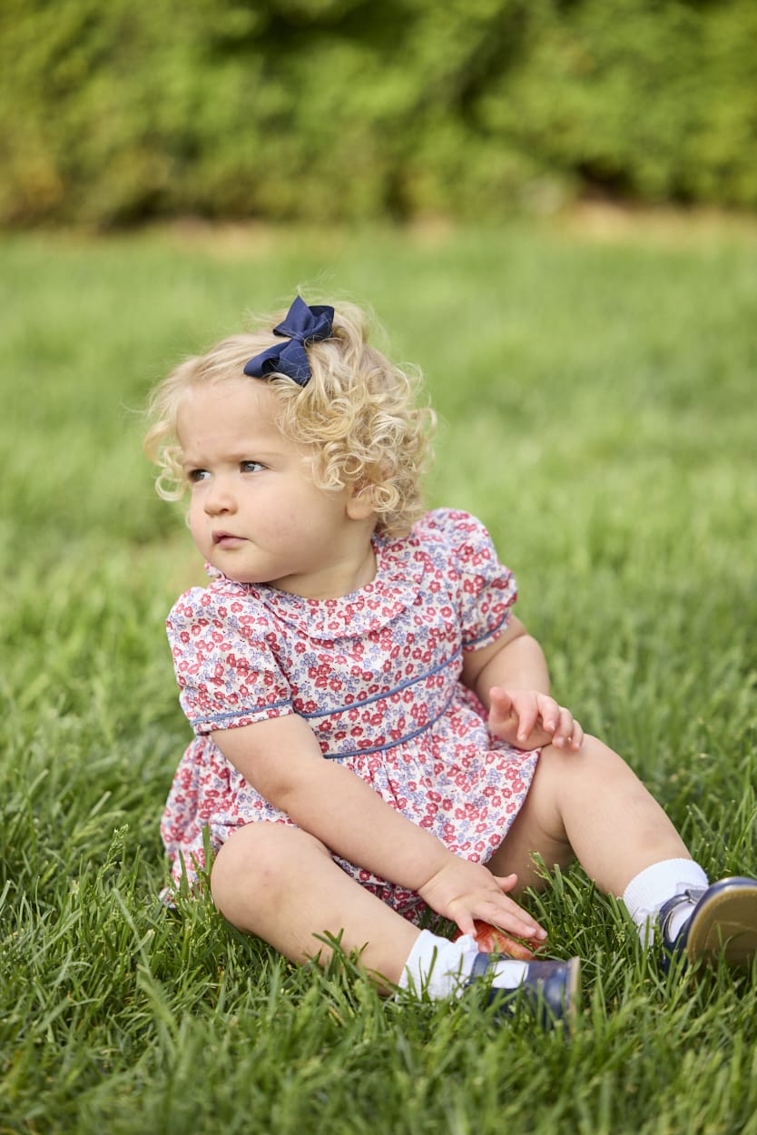 Little English traditional children's clothing.  Soft blue and Nantucket red Lennox Floral short sleeve bubble for baby girls with ruffle collar and blue piping detail at sleeves and chest