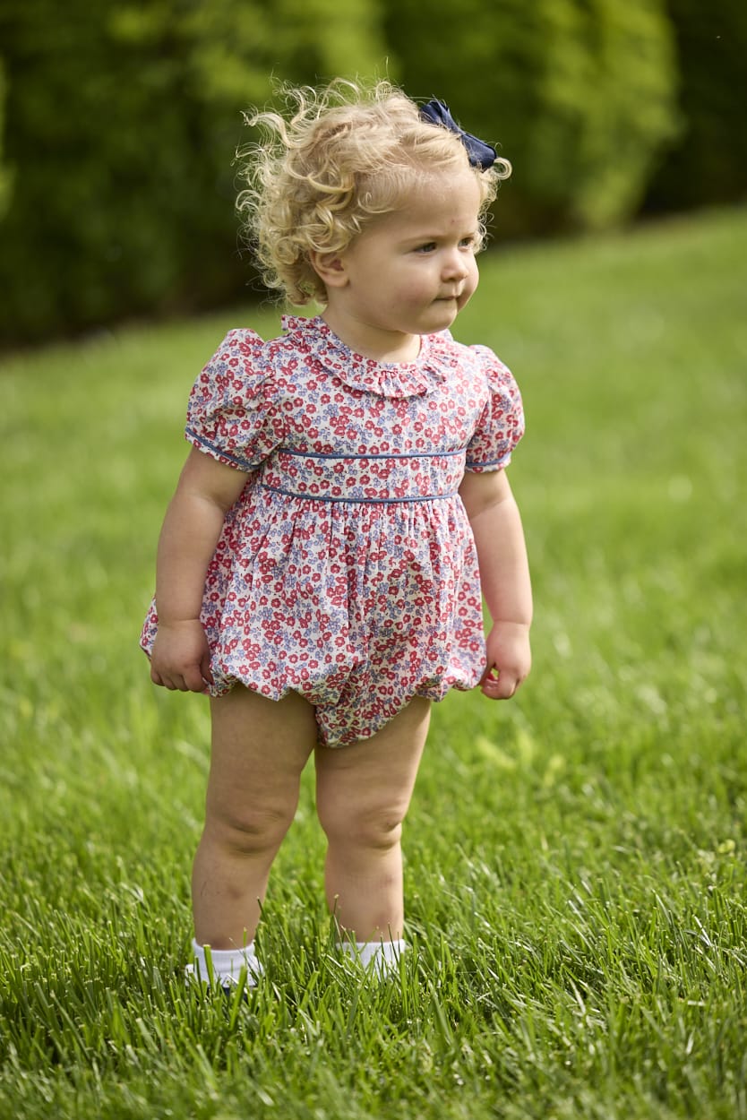Little English traditional children's clothing.  Soft blue and Nantucket red Lennox Floral short sleeve bubble for baby girls with ruffle collar and blue piping detail at sleeves and chest