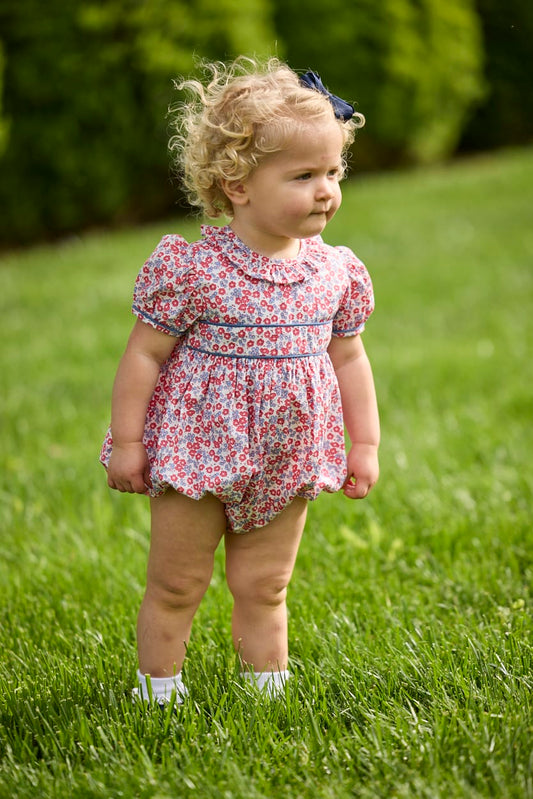 Little English traditional children's clothing.  Soft blue and Nantucket red Lennox Floral short sleeve bubble for baby girls with ruffle collar and blue piping detail at sleeves and chest