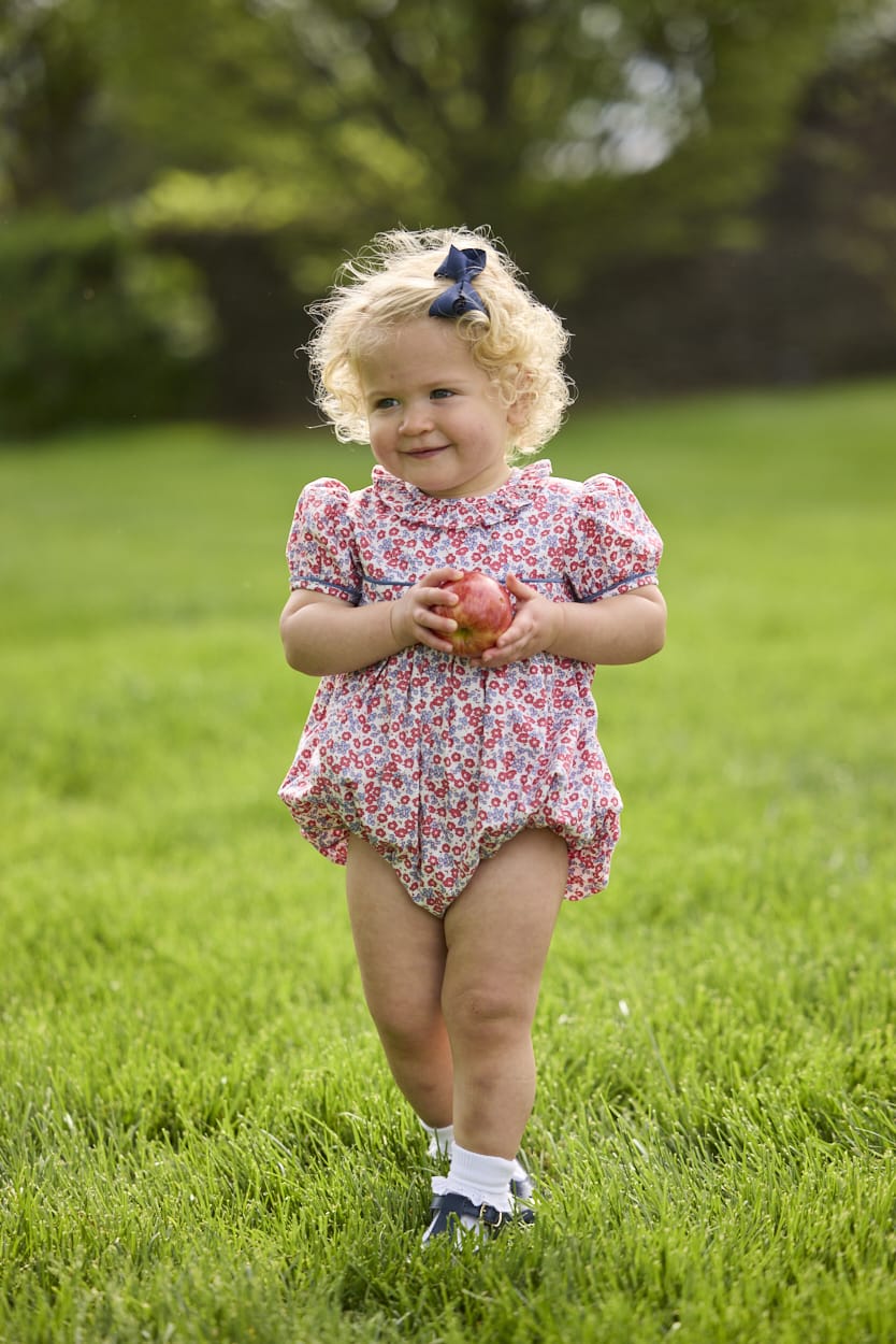 Little English traditional children's clothing.  Soft blue and Nantucket red Lennox Floral short sleeve bubble for baby girls with ruffle collar and blue piping detail at sleeves and chest