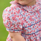 Little English traditional children's clothing.  Soft blue and Nantucket red Lennox Floral short sleeve bubble for baby girls with ruffle collar and blue piping detail at sleeves and chest