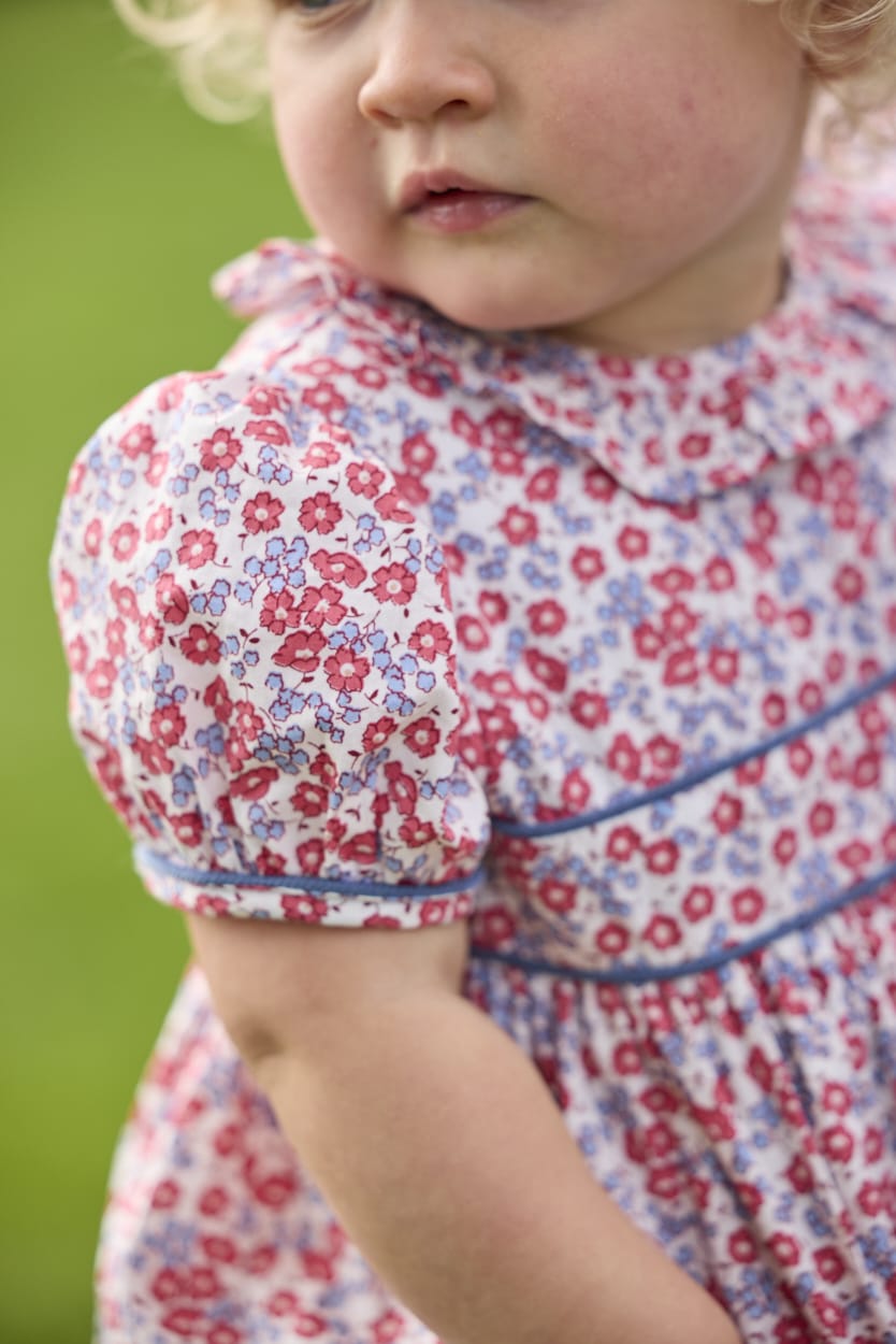 Little English traditional children's clothing.  Soft blue and Nantucket red Lennox Floral short sleeve bubble for baby girls with ruffle collar and blue piping detail at sleeves and chest