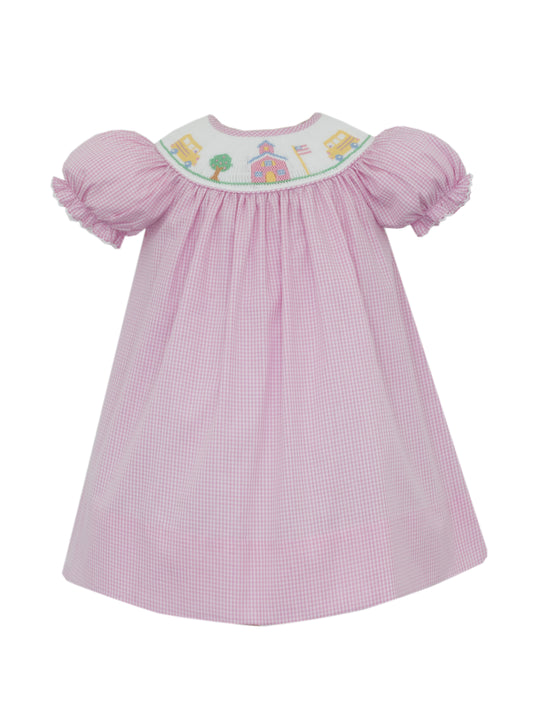 Pink checkered dress with embroidered top on a white background