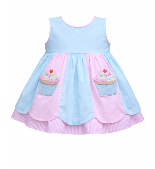 Sleeveless dress in baby pink and blue panels, featuring scalloped hem, two cupcake applique and pink seersucker underskirt. 