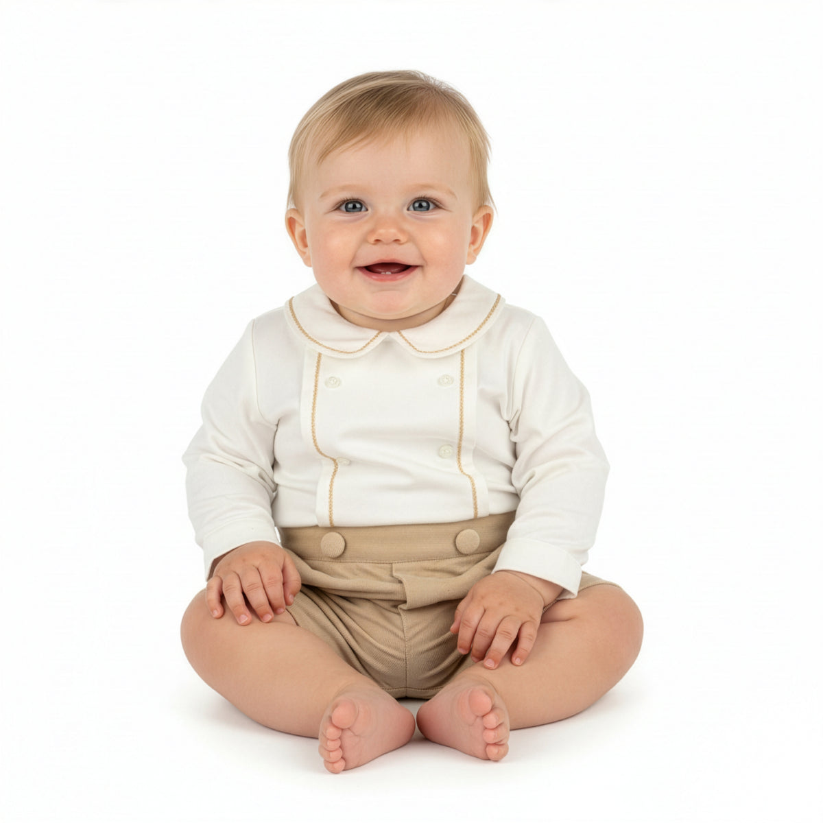 Baby wearing a white shirt with a collar and beige pants on a white background