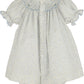 Floral dress with smocked neckline on a white background