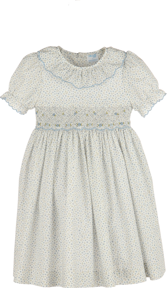 White dress with blue floral pattern on a white background
