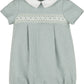 Green checkered baby romper with white collar on a white background