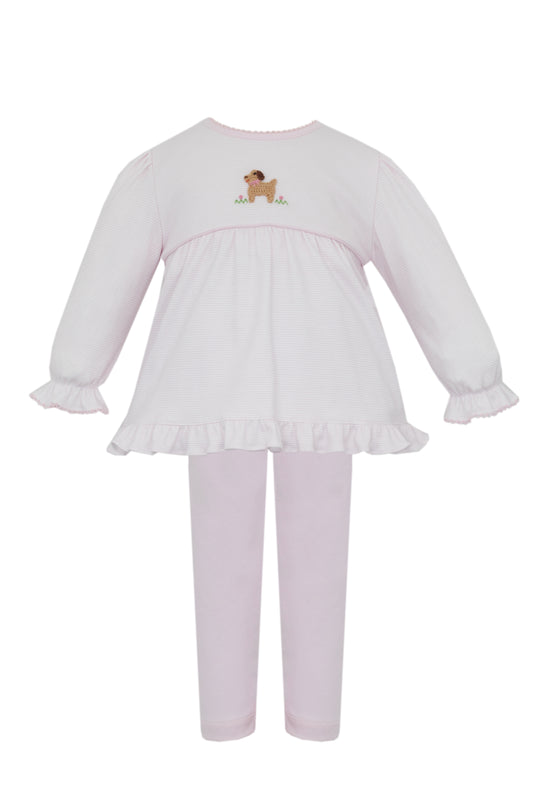 White dress with ruffled skirt and pink leggings on a white background
