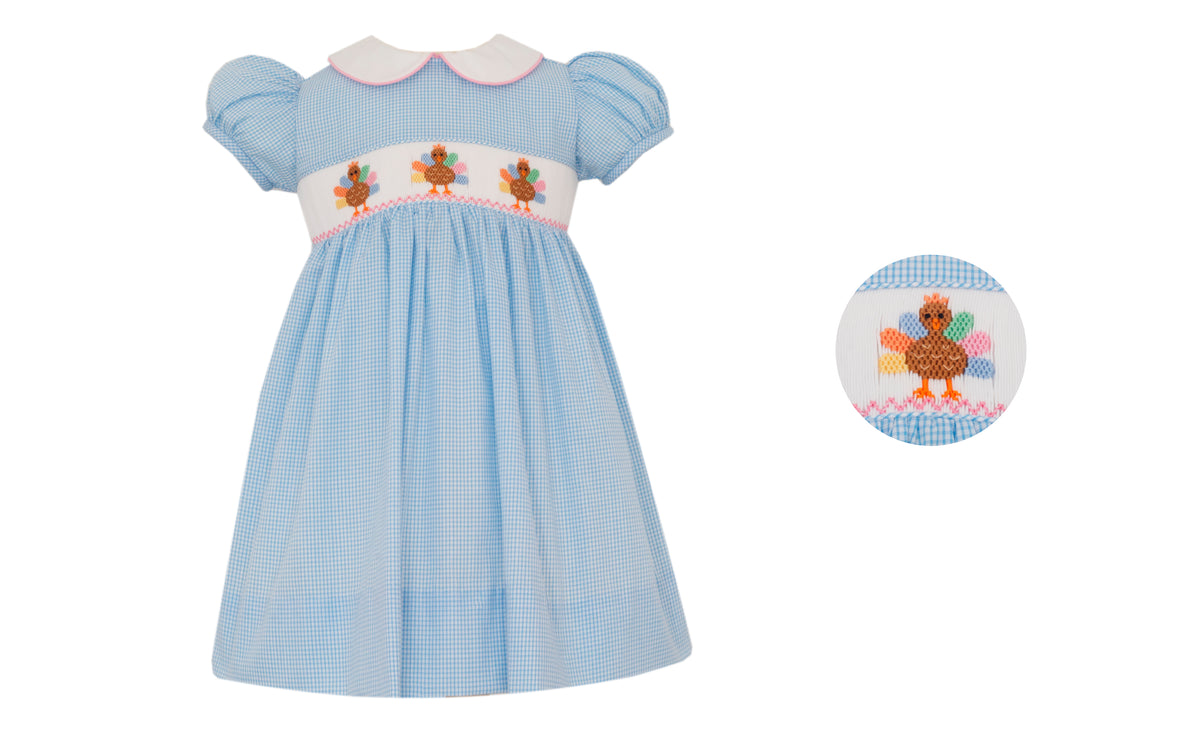 Light blue dress with embroidered design on a white background