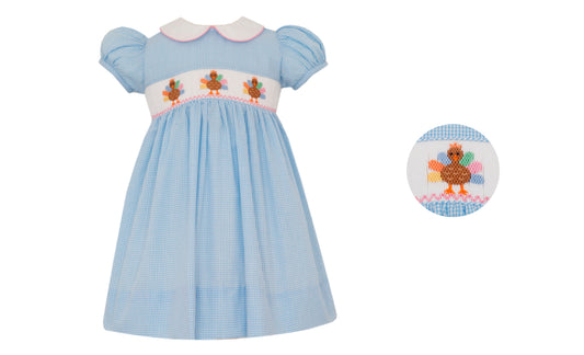 Light blue dress with embroidered design on a white background