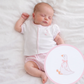 Baby girl in a white top with Goose embroidery on chest. edged in pink gingham with matching  pink gingham diaper cover. 