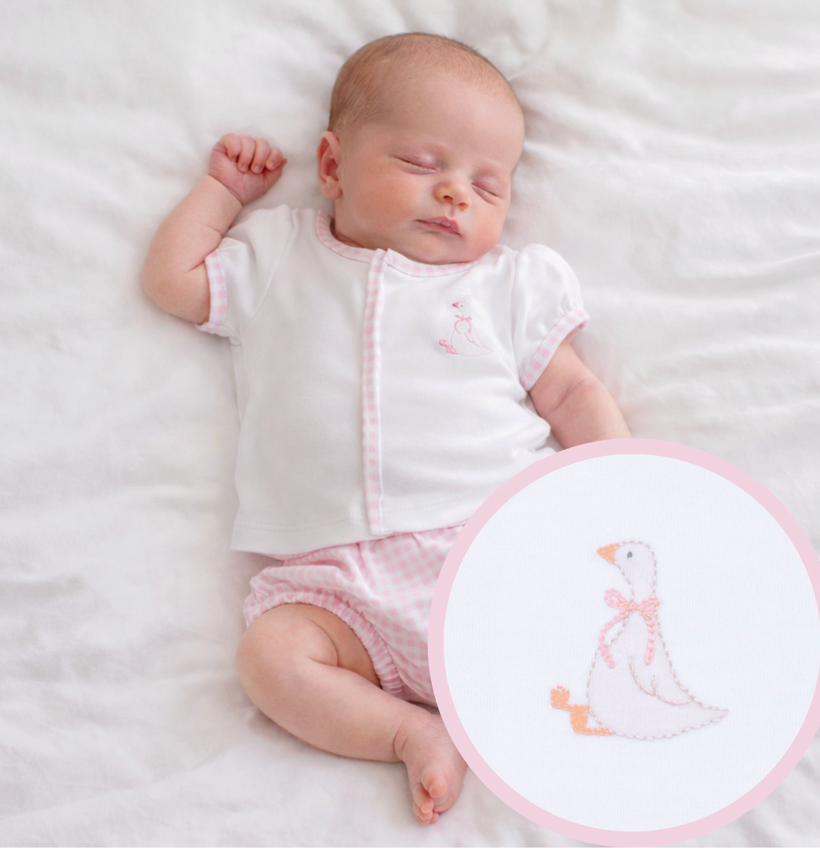 Baby girl in a white top with Goose embroidery on chest. edged in pink gingham with matching  pink gingham diaper cover. 