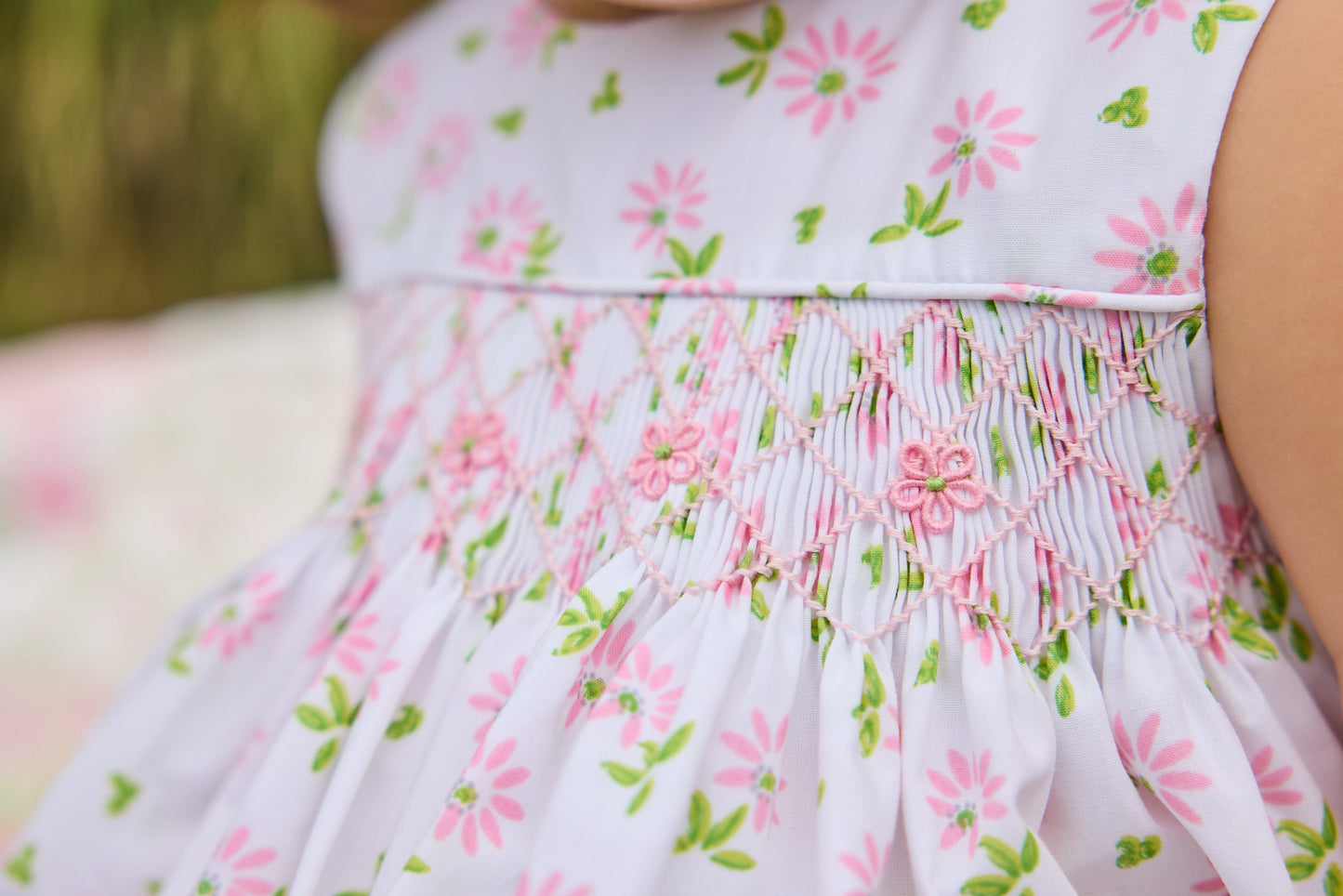 Little English traditional children's clothing.  White sleeveless smocked bubble with pink and green florals for baby girls