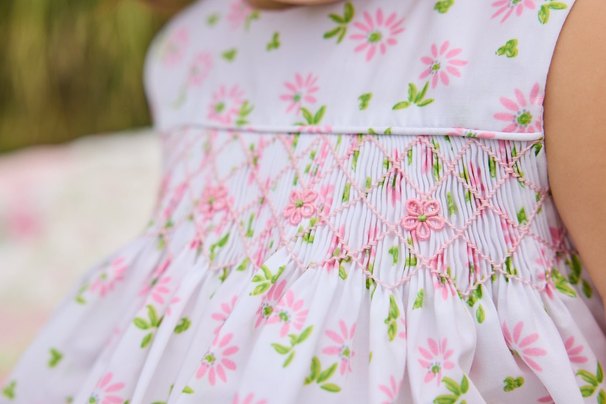 Little English traditional children's clothing.  White sleeveless smocked bubble with pink and green florals for baby girls
