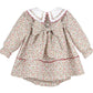 Floral baby dress with a white collar on a white background