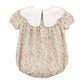 Floral baby romper with white collar on a white background