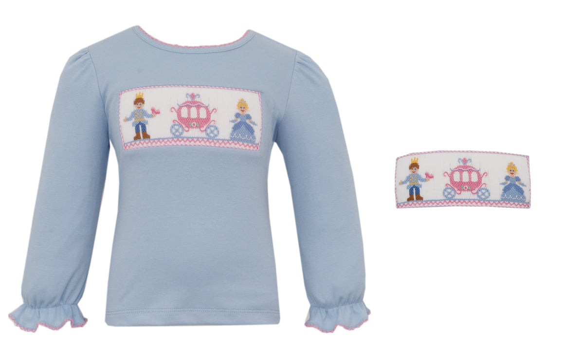 Light blue children's shirt with embroidered design on a white background