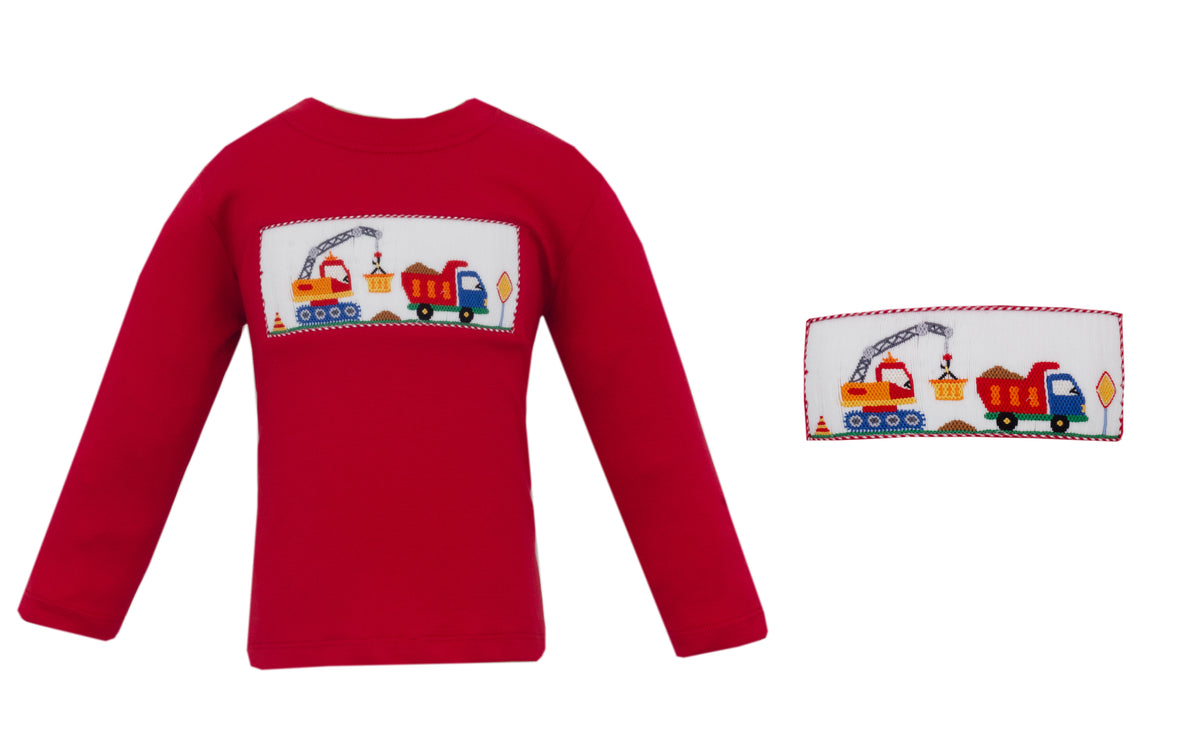 Red sweater with train design on a white background