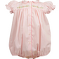 Pink baby romper with floral embroidery on a white background