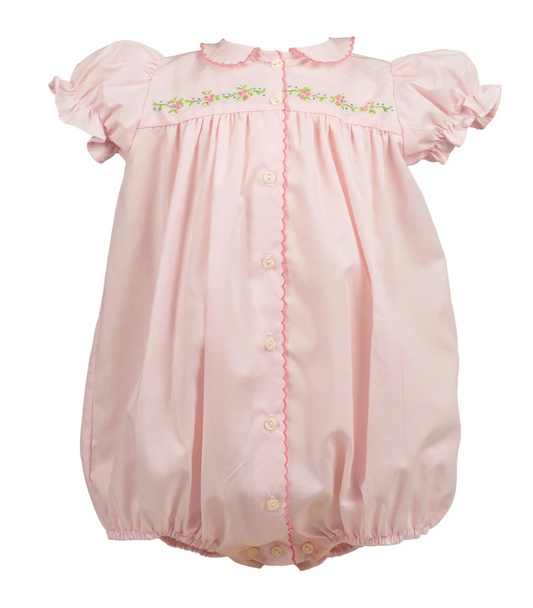Pink baby romper with floral embroidery on a white background
