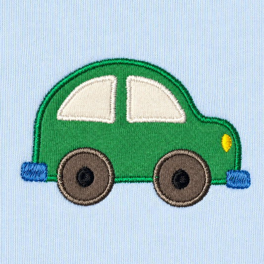 Close-up of the green car appliqué with cream windows, grey wheels, blue bumpers and a yellow headlight